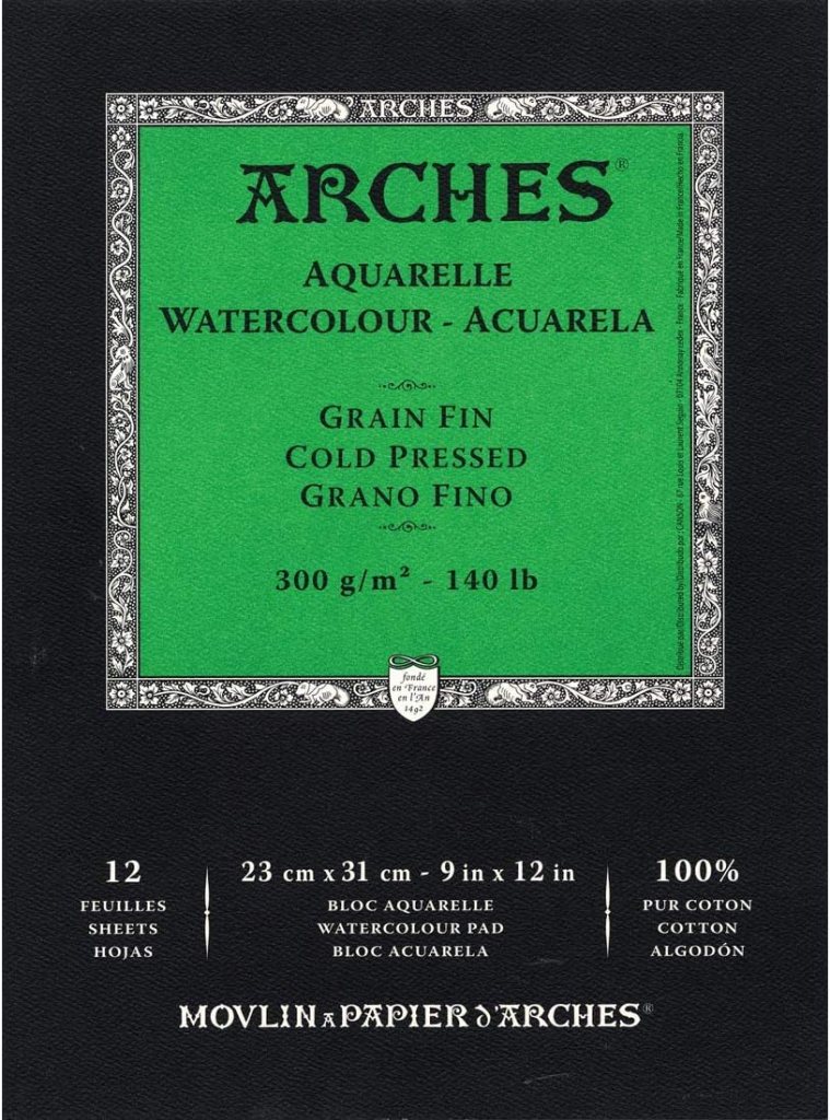 A package of Arches watercolor paper featuring a green label that indicates it contains 12 sheets, is 300 g/m², cold pressed, and made of 100% cotton. The dimensions are 23 cm x 31 cm (9 in x 12 in).