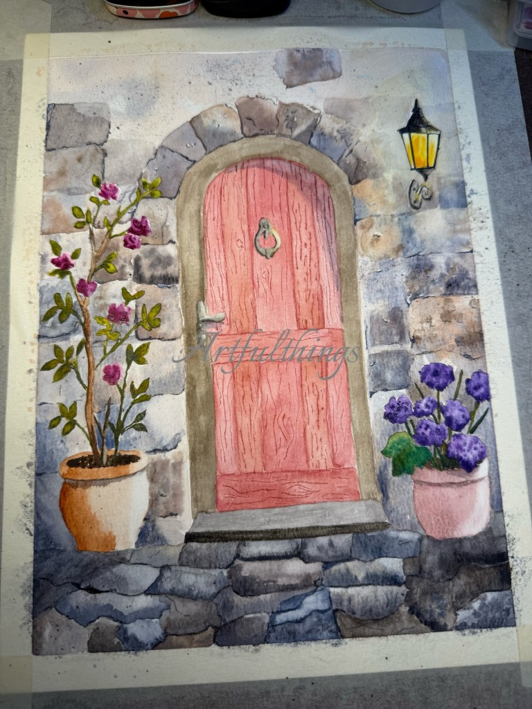 A watercolor painting of a pink door framed by stone walls, with a lantern above and flower pots on either side featuring blooming plants.